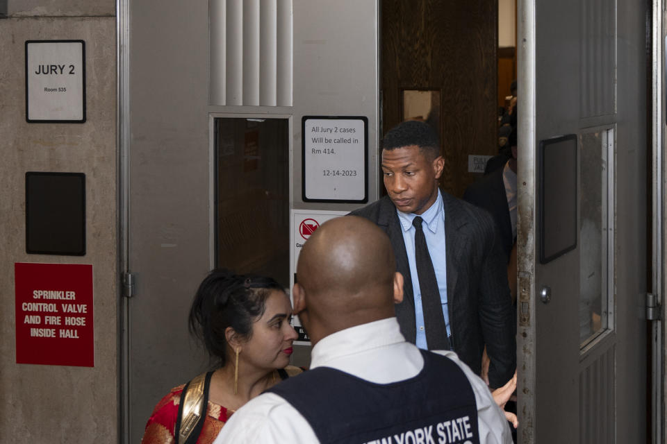 Jonathan Majors, accompanied by girlfriend Meagan Good, exits a courtroom at the Manhattan Criminal Courthouse in New York, Thursday, Dec. 14, 2023. (AP Photo/Peter K. Afriyie)