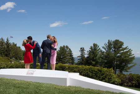 European Council President Donald Tusk (2nd R) and his wife Malgorzata (L) are greeted by Canada's Prime Minister Justin Trudeau and his wife Sophie Gregoire Trudeau during the official welcoming ceremony the G7 Summit in the Charlevoix town of La Malbaie, Quebec, Canada, June 8, 2018. REUTERS/Christinne Muschi