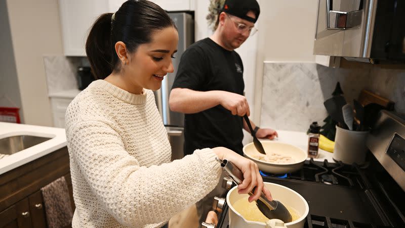 Kaitlyn Gordon and her husband, Zach Gordon, talk as they prepare a meal in their new home in Spanish Fork on Tuesday, Nov. 21, 2023.