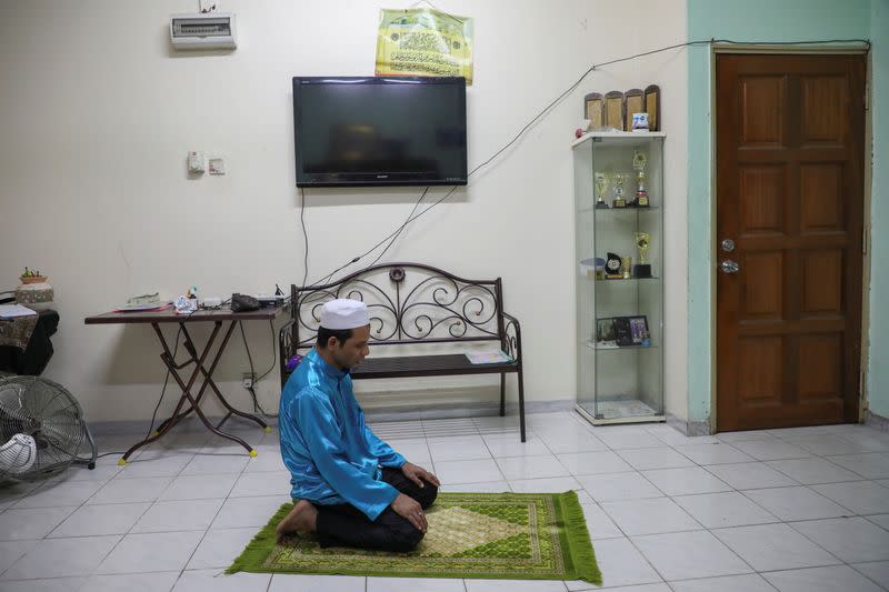 Rohingya refugee and activist Zafar Ahmad Abdul Ghani prays at his home in Kuala Lumpur