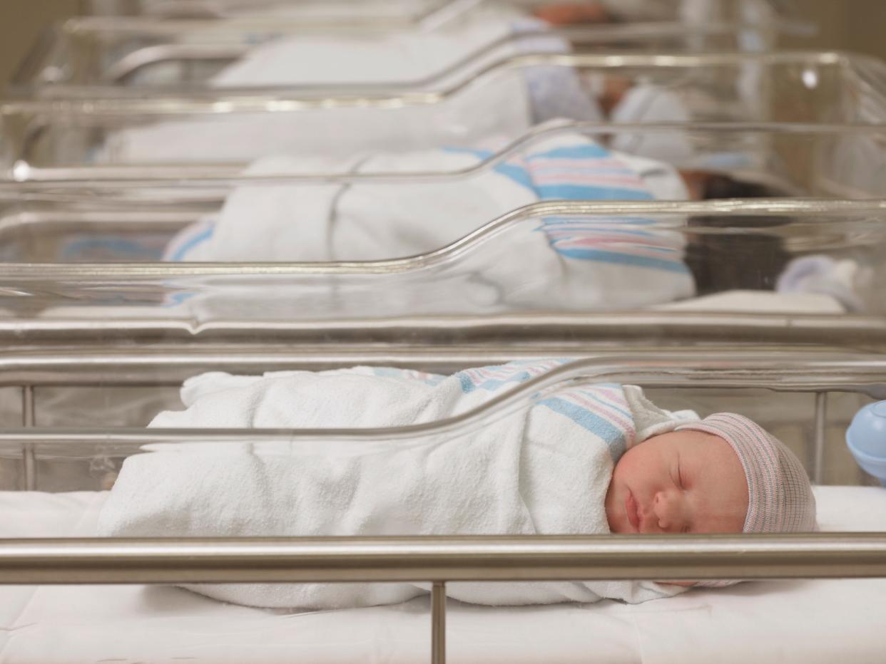 Newborn babies sleeping in hospital nursery.