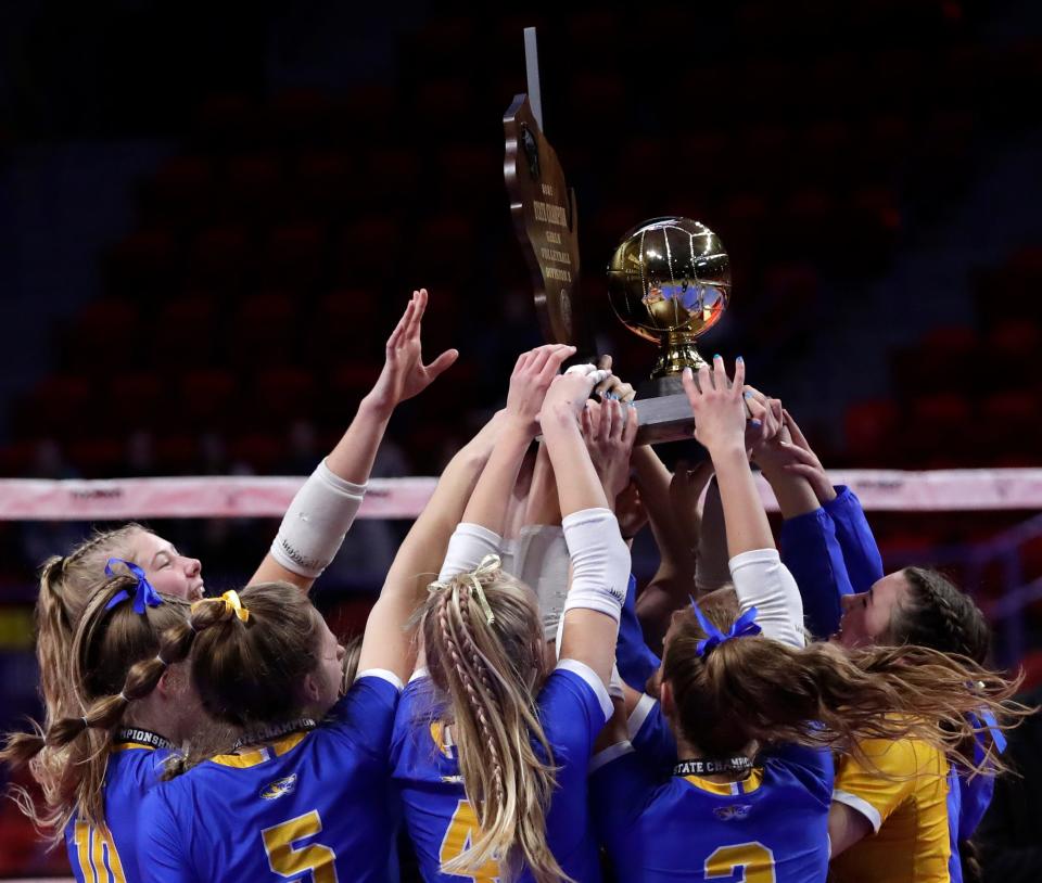 Howards Grove players hold up their trophy after winning the WIAA Division 3 girls volleyball championship on Nov. 6, 2021, at the Resch Center in Ashwaubenon, Wis.