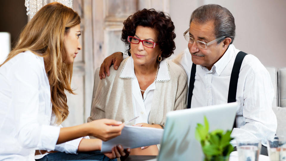 Financial consultant presents bank investments to a senior couple.