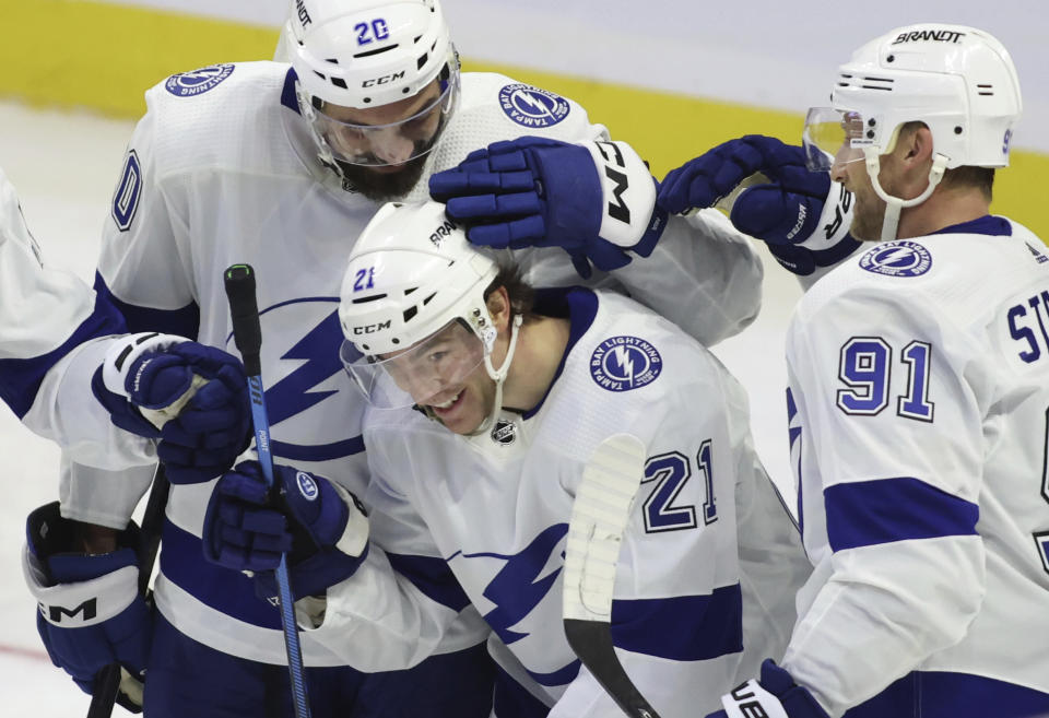 Tampa Bay Lightning's Brayden Point (21) celebrates his third goal of the night against the Ottawa Senators with Nick Paul (20) and Steven Stamkos (91) during the third period of an NHL hockey game Saturday, Nov. 4, 2023, in Ottawa, Ontario. (Patrick Doyle/The Canadian Press via AP)