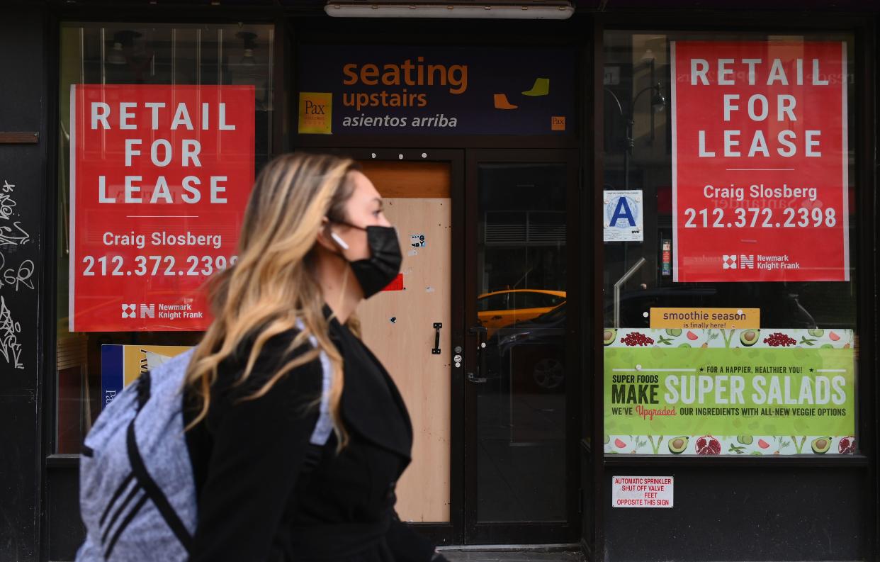 A woman walks past a closed retail store for lease in midtown Manhattan.