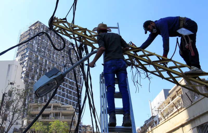 Workers fix damaged cables following Tuesday's blast in Beirut's port area