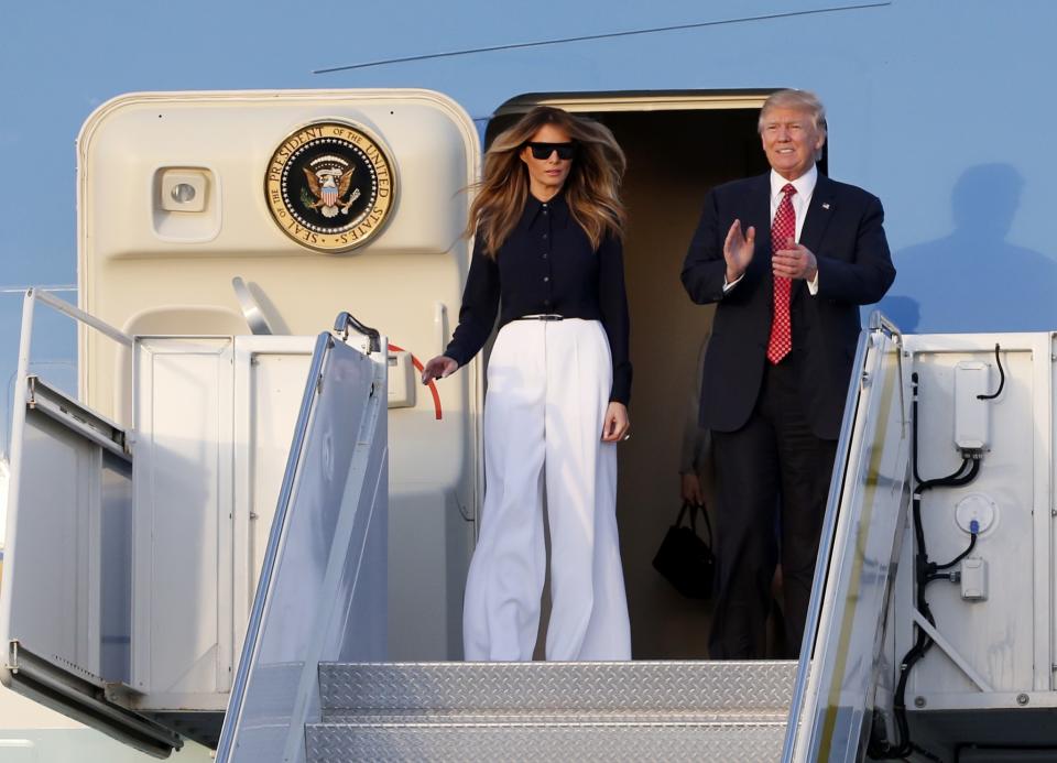 <p>The host Japanese Prime Minister Shinzo Abe and his wife Akie Abe, the Trumps invited the couple to their Mar-a-Lago estate for the weekend. For the trip from Andrews Air Force Base in Md. to Palm Beach, Fla., Melania Trump dressed in a fashionable yet comfortable ensemble from Michael Kors. The FLOTUS paired white wide-legged pants with a black blouse and matching black wool coat that she casually draped over her shoulders. When previously asked about dressing the first lady, <span>Kors said</span>, “That’s none of my business.” Melania previously wore Michael Kors on election day in November when she went to cast her vote in New York City. (Photo: AP) </p>