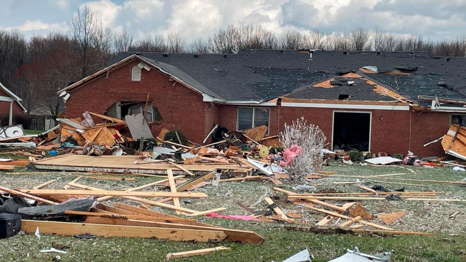 PHOTO: Debris covers the ground in front of a damaged home after severe weather passed the area, March 14, 2024  in Jefferson Manor Subdivision near Hanover, Ind.  (Sgt. Stephen Wheeles/AP)