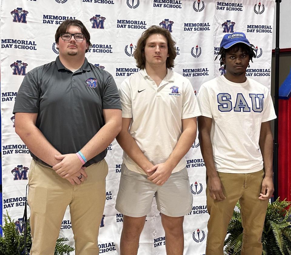 Memorial Day's Joseph Barnes, Tyler Kindle and Craig Harris (from left to right) signed to play college football on Thursday.