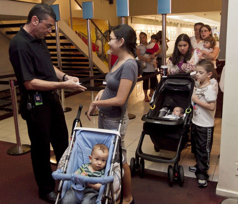 Mothers arrive at a movie theatre as part of the CineMaterna program, in Sao Paulo, Brazil, in April 2011. CineMaterna is an NGO that promotes the return of mothers of up to eighteen-month-old babies to the cultural life by offering them specially suited movie sessions