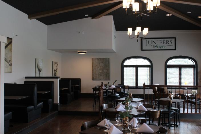 The newly renovated dining room at the Junipers Restaurant has golf-related art, a nod to the golf course surrounding it.