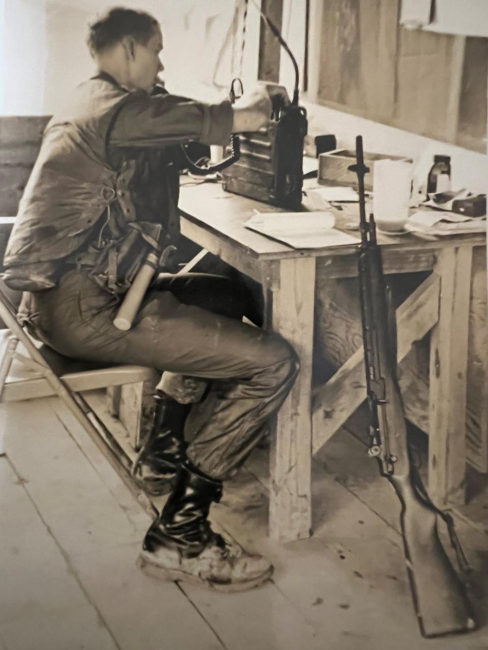 Harvey Arnold communicates with fellow Army soldiers in perimeter bunkers at base camp in Long Dinh, South Vietnam in 1966 or 1967.