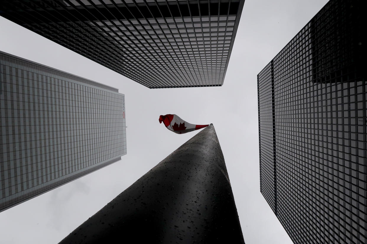 TORONTO, CANADA - NOVEMBER 16: A Canadian flag flies in a plaza in the center of towers representing two of Canada's five major banks, the Toronto-Dominion Bank and the Bank of Montreal on November 16, 2018 in Toronto, Ontario, Canada. (Photo by Gary Hershorn/Getty Images)