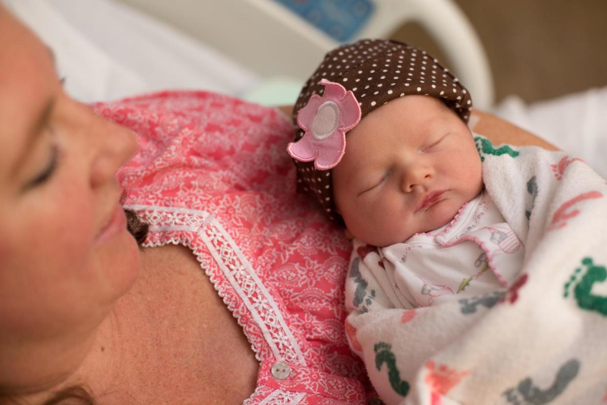 <span>Kristin Dillensnyder holds her daughter she conceived through IVF.</span><span>Photograph: Stephen Poff/Courtesy Kristin Dillensnyder</span>