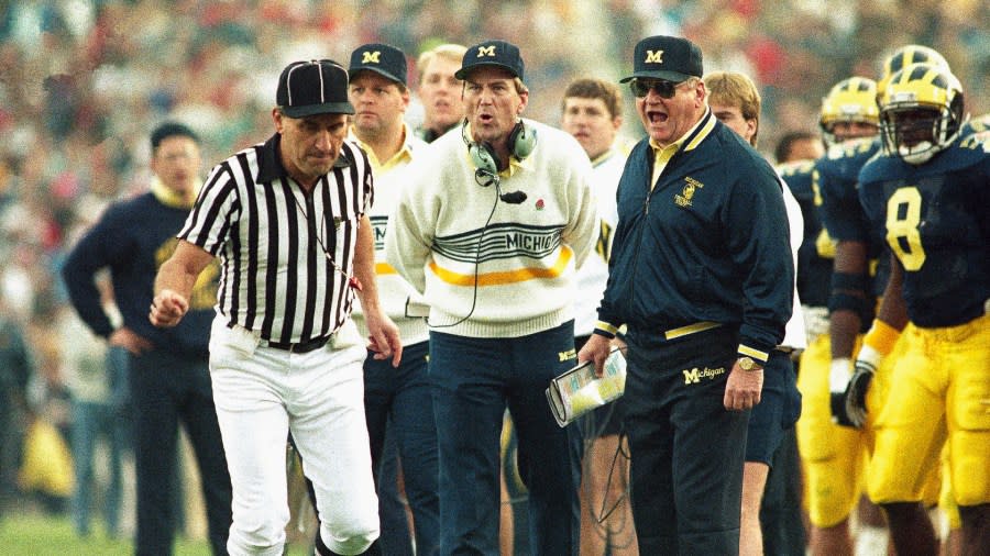 Bo Schembechler and Lloyd Carr both take off their headsets to yell at a nearby official.