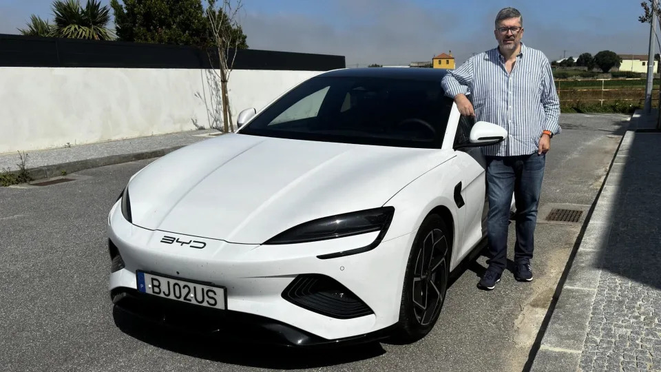 Portuguese business executive Luis Costa standing next to his BYD Seal.