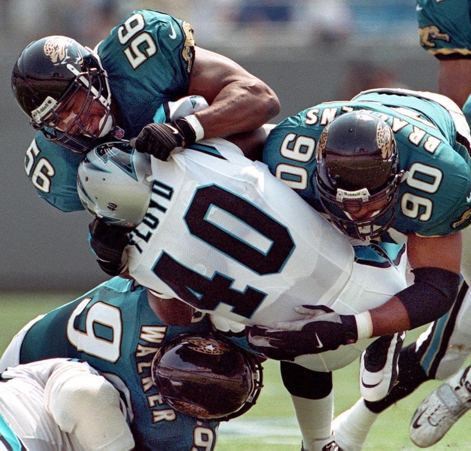 Tony Brackens (90), seen here in a game in 1999, is the Jaguars franchise leader for sacks.