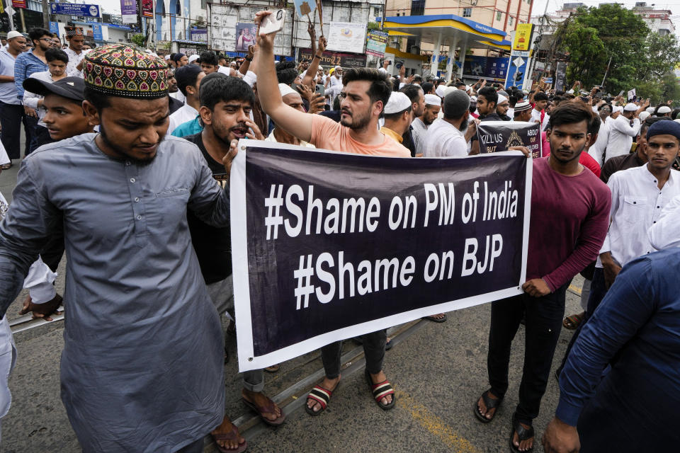 Indian Muslims block road as they protest against the spokesperson of governing Hindu nationalist party as they react to the derogatory references to Islam and the Prophet Muhammad in Kolkata, India, Friday, June 10, 2022. Thousands of Muslims emerging from mosques after Friday prayers held street protests and hurled rocks at the police in some Indian towns and cities over remarks by two officials from India’s ruling party that were derogatory to the Prophet Muhammad. (AP Photo/Bikas Das)