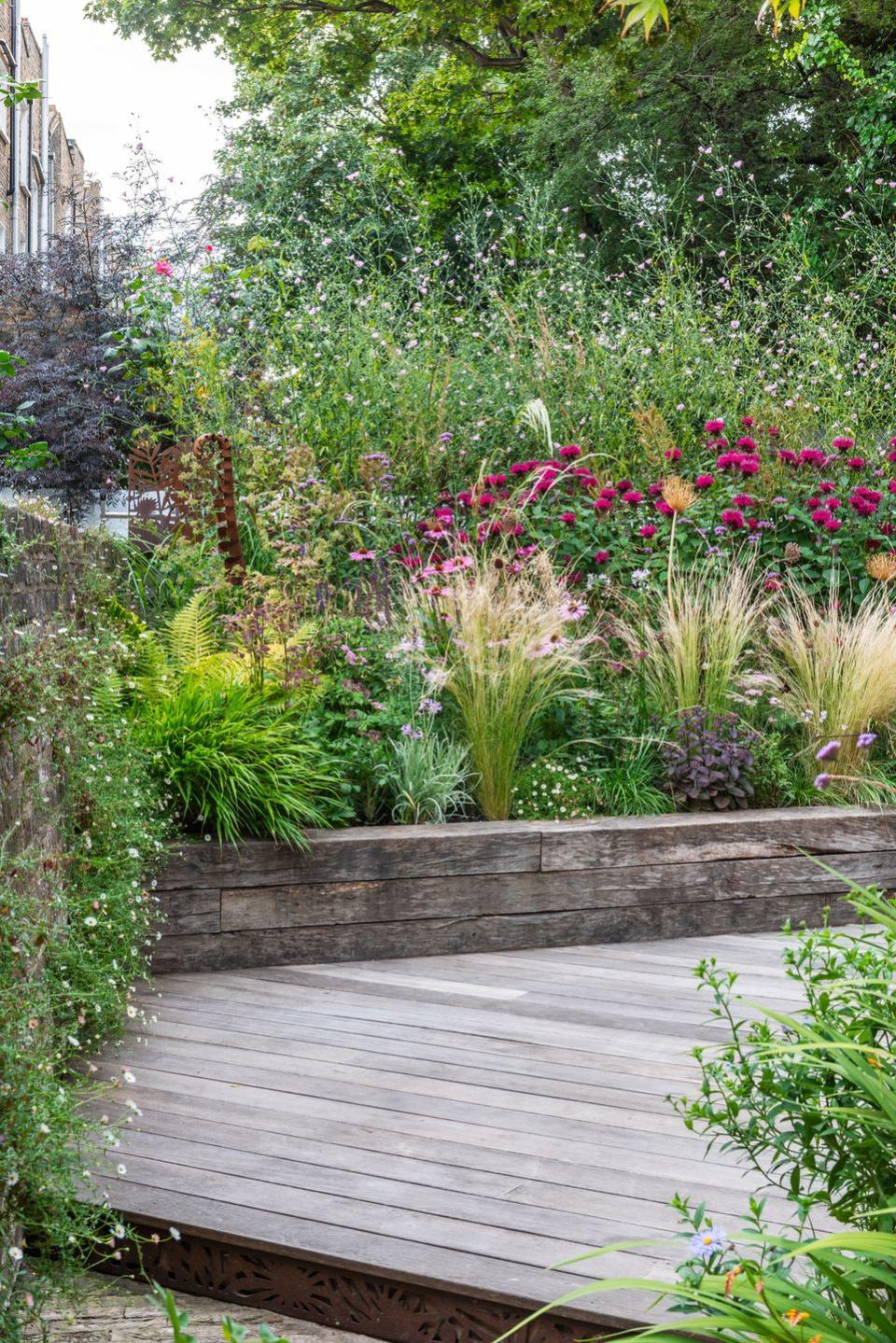 a wooden walkway in a garden