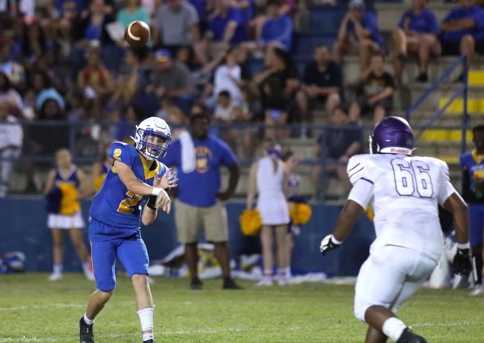 Newberry High quarterback Mason Smith (2) throws against the Gainesville High School defense, during a spring football game in Newberry, May 20, 2022.