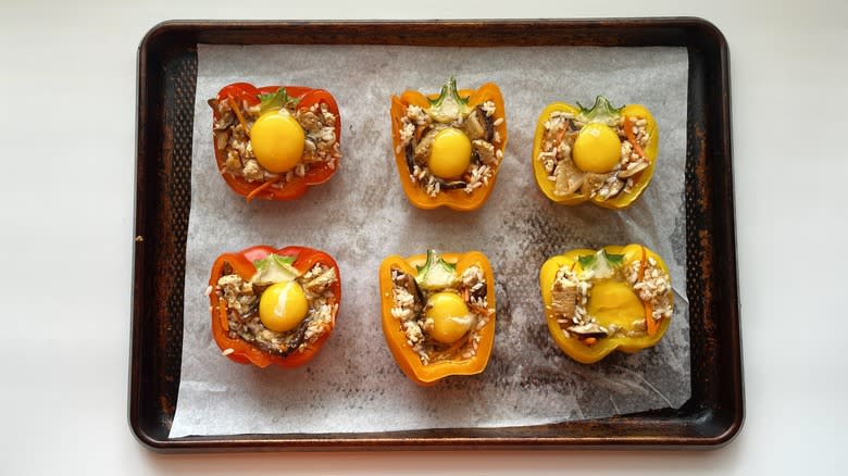 stuffed bell peppers with egg on baking sheet
