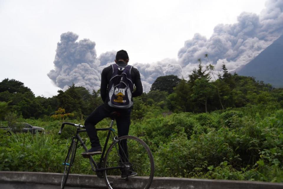 <p>A man looks at the Fuego Volcano in eruption, from Alotenango municipality, Sacatepequez department. (Getty) </p>