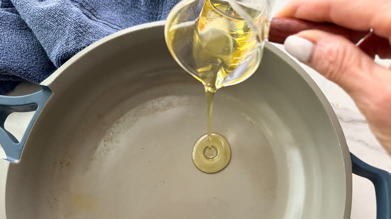 adding oil to a pan