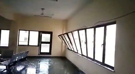 A strong wind blows a glass window into a building during Cyclone Fani in Bhubaneswar, Odisha, India May 3, 2019 in this still image taken from a video obtained from social media. AMAN PRATAP SINGH/via REUTERS