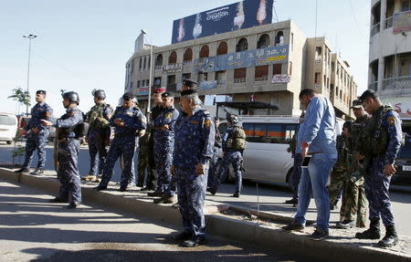 Iraqi security forces gather at the site of a bomb attack in Baghdad's Bab Sharji district, March 29, 2016. REUTERS/Khalid al Mousily