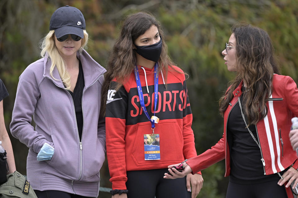 Sam Alexis Woods, center, Elin Nordegren, left, and Erica Herman follow Tiger Woods and Charlie Woods on the 11th hole during the final round of the PNC Championship golf tournament, Sunday, Dec. 20, 2020, in Orlando, Fla. (AP Photo/Phelan M. Ebenhack)