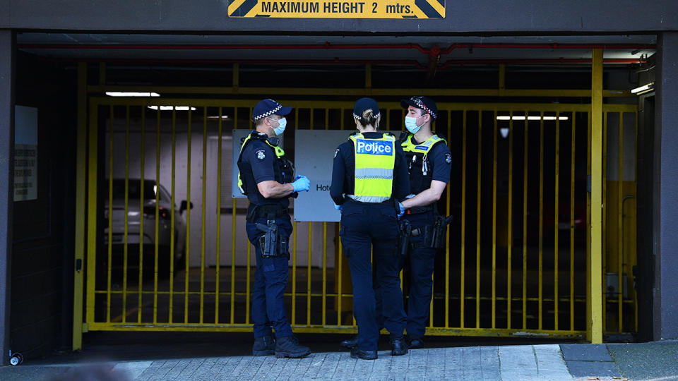 Victorian Police officers, pictured here standing guard outside the Park hotel government immigration facility where Novak Djokovic is being held. 