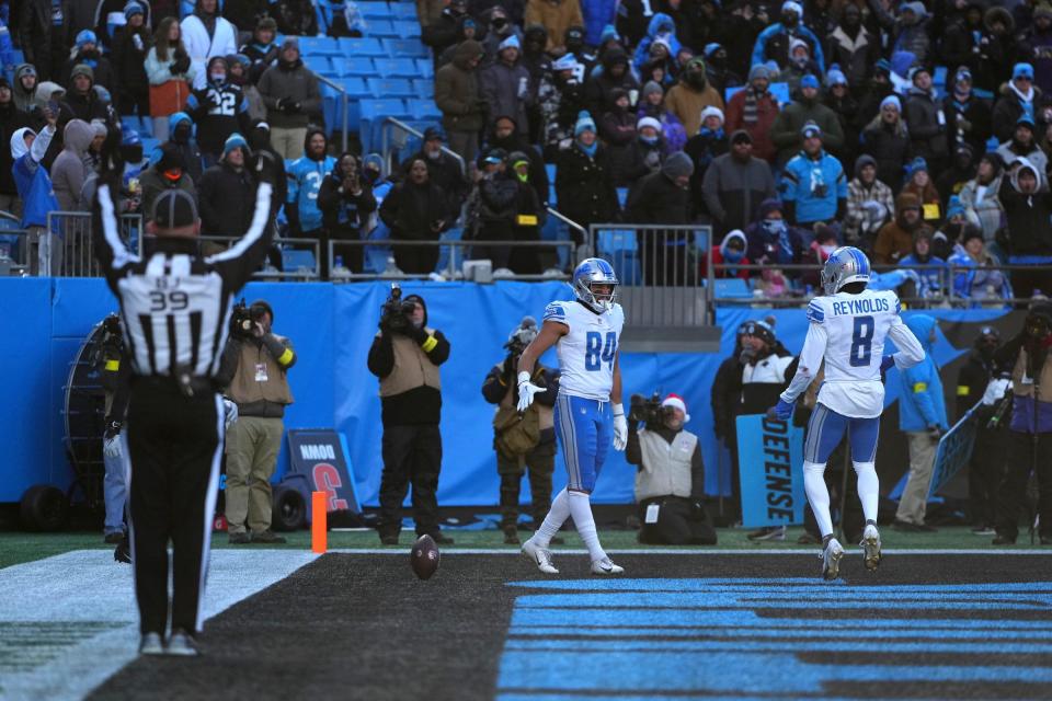 Detroit Lions tight end Shane Zylstra (84) celebrates with wide receiver Josh Reynolds (8) after scoring a touchdown in the third quarter at Bank of America Stadium.