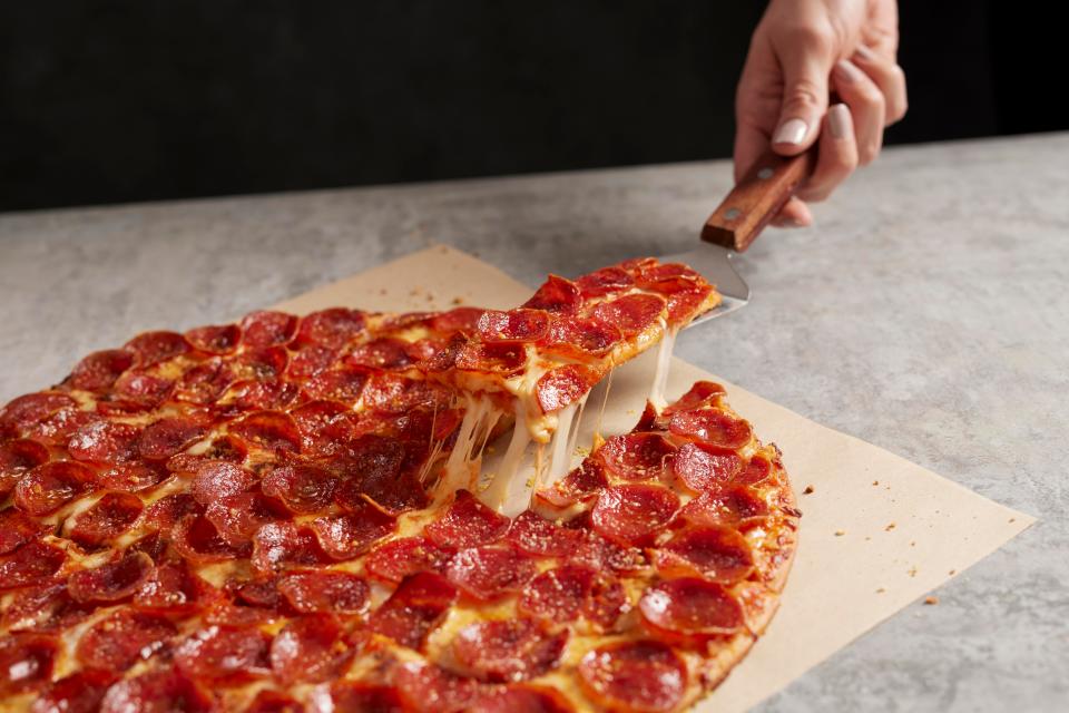 Donatos stretches the sauce to the crust. On this 14" pie, there are 100 pepperoni slices.