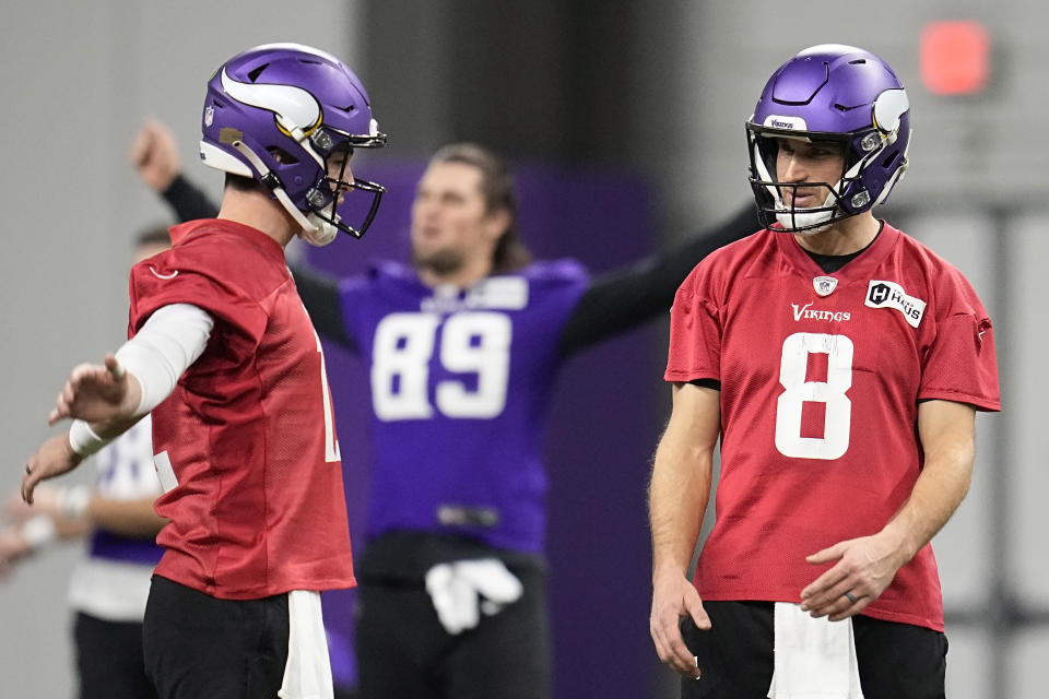 Minnesota Vikings quarterbacks Nick Mullens (12), left, and Kirk Cousins (8) take part in drills during an NFL football team practice in Eagan, Minn., Wednesday, Jan. 11, 2023. The Vikings will play the New York Giants in a wild-card game on Sunday. (AP Photo/Abbie Parr)