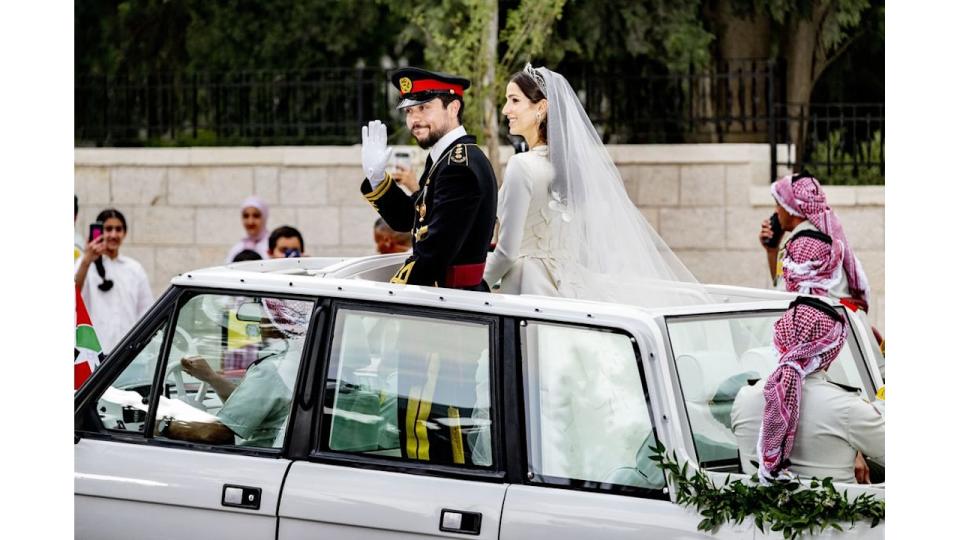 Princess Rajwa and Prince Hussein on a Range Rover after their wedding ceremony