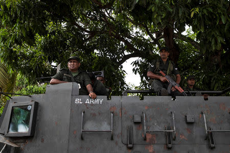 Soldiers stand guard on an armoured vehicle outside St. Sebastian Church, days after a string of suicide bomb attacks across the island on Easter Sunday, in Negombo, Sri Lanka, May 1, 2019. REUTERS/Danish Siddiqui