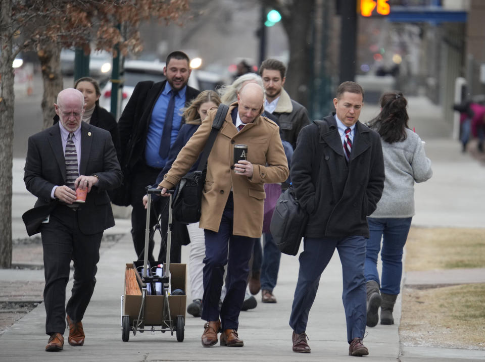 Michael J. Allen, front right, district attorney for Colorado's Fourth Judicial District, leads a contingent of attorneys into the El Paso County courthouse for a preliminary hearing for the alleged shooter in the Club Q mass shooting Wednesday, Feb. 22, 2023, in Colorado Springs, Colo. (AP Photo/David Zalubowski)