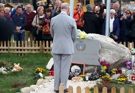 Britain's Prince Charles pays his respects for the victims of the earthquake as he visit to the town of Amatrice, which was levelled after an earthquake last year, in central Italy April 2, 2017. REUTERS/Alessandro Bianchi