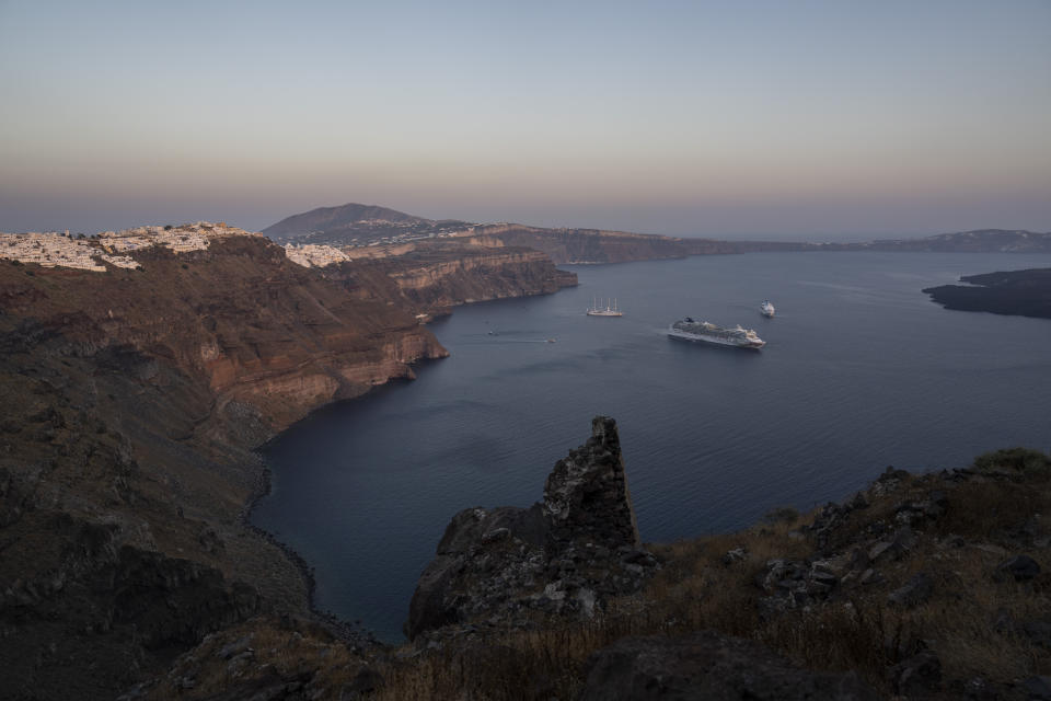 Ruins of a settlement, including a former Catholic monastery, lie on the rocky promontory of Skaros on the Greek island of Santorini on Wednesday, June 15, 2022. The Monastery of St. Catherine was founded at Skaros in 1596, but after an earthquake it was moved to the nearby village of Thira, where to this day it remains home to more than a dozen nuns who devote themselves to prayer. (AP Photo/Petros Giannakouris)