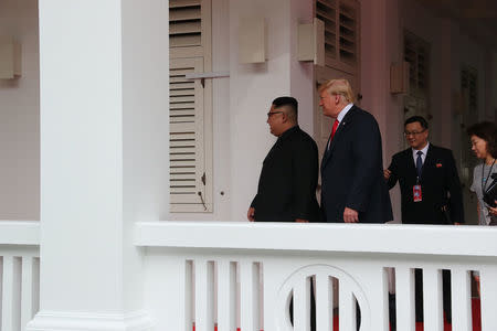 U.S. President Donald Trump walks with North Korean leader Kim Jong Un at the Capella Hotel on Sentosa island in Singapore June 12, 2018. REUTERS/Jonathan Ernst