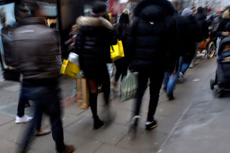 FILE PHOTO: People shop for last-minute purchases before Christmas on Oxford Street in London, Britain December 23, 2017. REUTERS/Mary Turner/File Photo