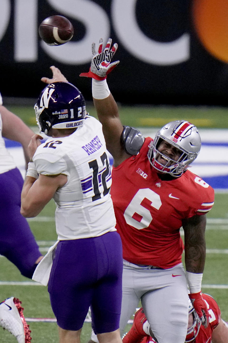 Northwestern quarterback Peyton Ramsey (12) throws over Ohio State defensive tackle Taron Vincent (6) during the first half of the Big Ten championship NCAA college football game, Saturday, Dec. 19, 2020, in Indianapolis. (AP Photo/AJ Mast)