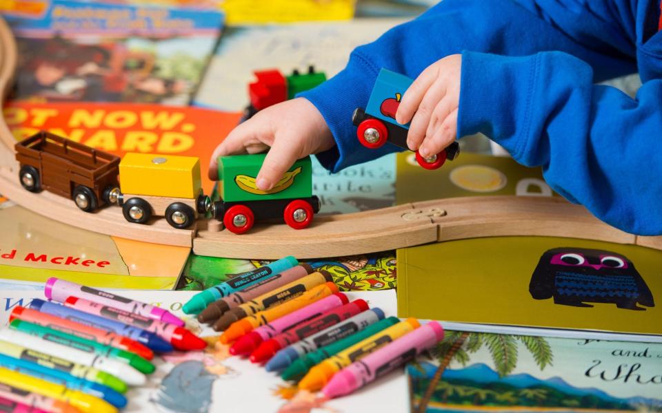 A toddler playing with toys - PA