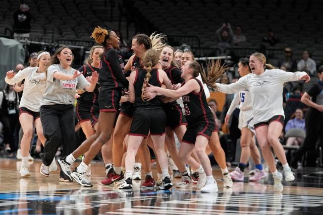 Transylvania players celebrate after winning the NCAA Women’s Division III championship game against Christopher Newport on Saturday in Dallas. “It means the world to us to actually see a dream come to fruition and to see all our hard work pay off,” the Pioneers’ Madison Kellione said.