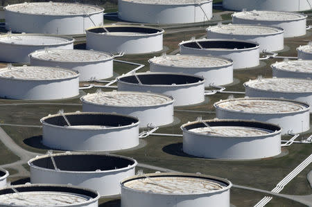 Crude oil storage tanks are seen from above at the Cushing oil hub, appearing to run out of space to contain a historic supply glut that has hammered prices, in Cushing, Oklahoma, U.S. on March 24, 2016. REUTERS/Nick Oxford/File Photo