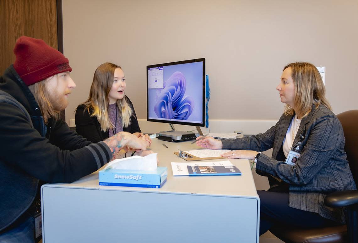 Kristen Spykerman, right, chief clinical officer for Network 180, meets with Taylor Beals, mobile crisis response clinician, and Mariekie Barone, a mobile crisis response manager. The county mental health authority, Network 180 is a lead agency helping spearhead collaboration in Grand Rapids, Michigan.