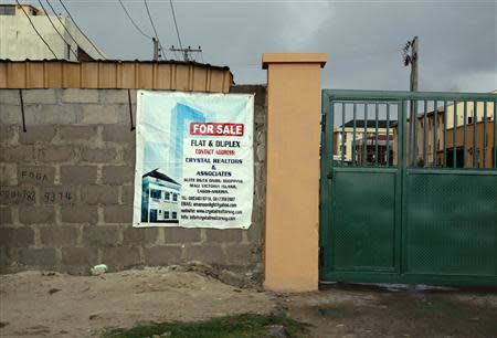 A sign advertising the sale of a house is pasted on a wall in the Victoria Island district in Nigeria's commercial capital Lagos September 10, 2013. REUTERS/Akintunde Akinleye