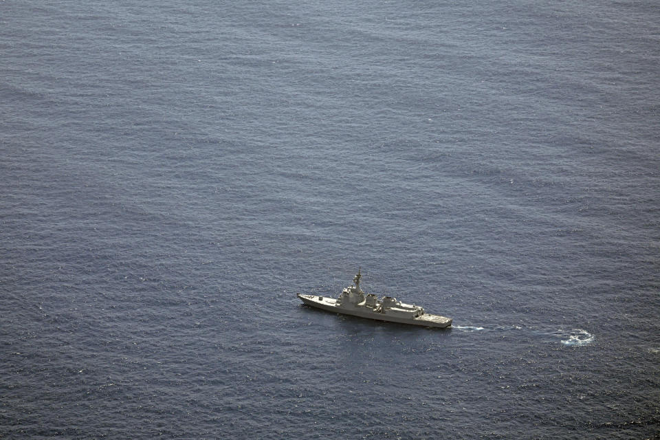 A Japan's Maritime Self-Defense Force vessel sails near the site of a crash in the Pacific Ocean Sunday, April 21, 2024. Two Japanese navy helicopters carrying eight crew members crashed in the Pacific Ocean south of Tokyo during a nighttime training flight after possibly colliding with each other, the country's defense minister said Sunday. (Kyodo News via AP)