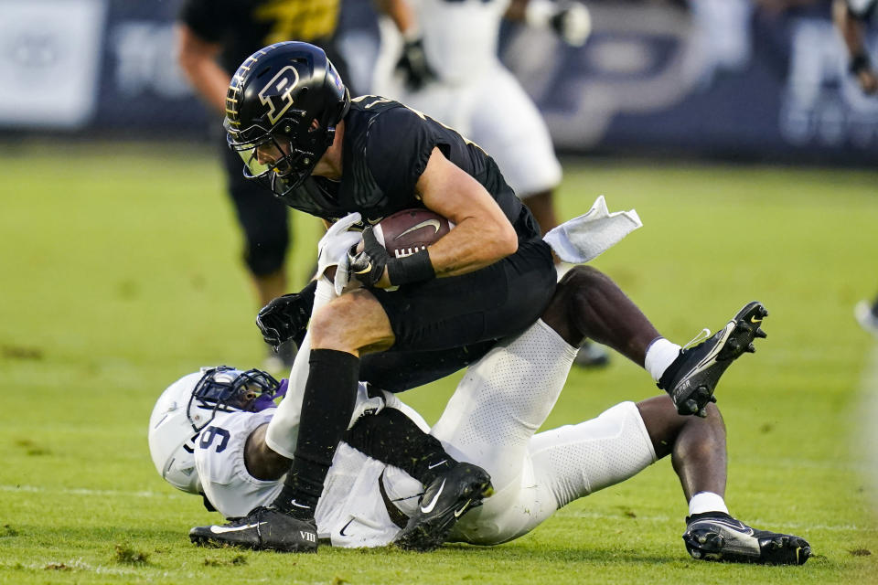Purdue wide receiver Charlie Jones is tackled by Penn State cornerback Joey Porter Jr. (9) during the first half of an NCAA college football game in West Lafayette, Ind., Thursday, Sept. 1, 2022. (AP Photo/Michael Conroy)