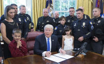 <p>U.S. President Donald Trump signs a proclamation supporting police officers at the White House on May 15, 2017 in Washington, D.C. (Photo: Chris Kleponis-Pool/Getty Images) </p>